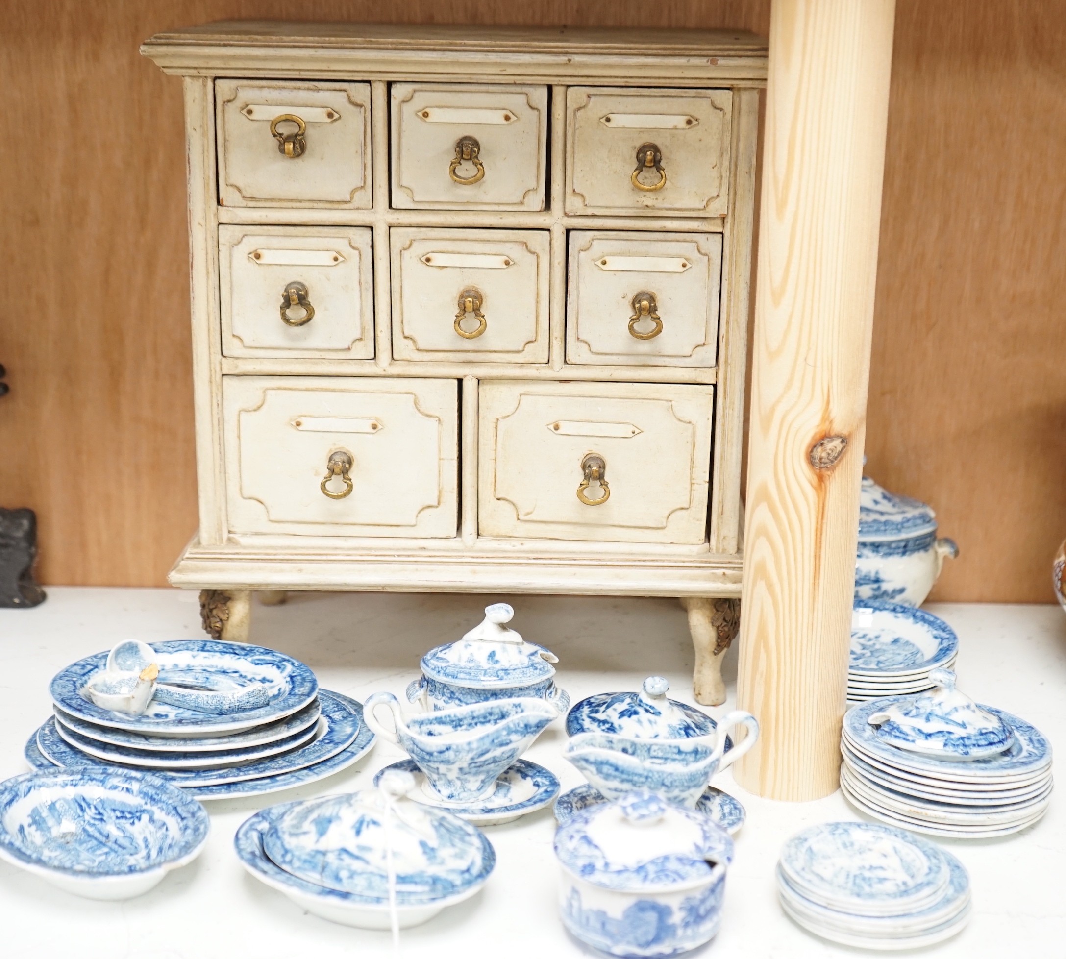 A Victorian toy-size blue and white dinner service and a painted wooden miniature chest, chest 27cms high